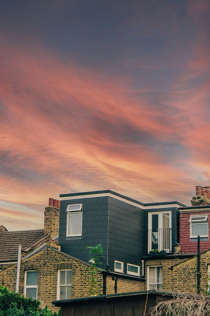Picturesque scene of London houses against a vibrant sunset sky.